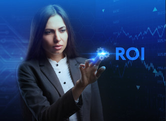 The concept of business, technology, the Internet and the network. A young entrepreneur working on a virtual screen of the future and sees the inscription: ROI