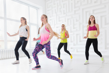 Group of happy young women having a fitness dance class