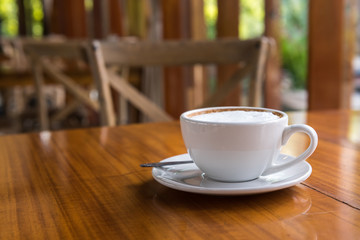Cappuccino cup on wooden table