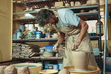 Creating a jar or vase of white clay close-up. Master crock.