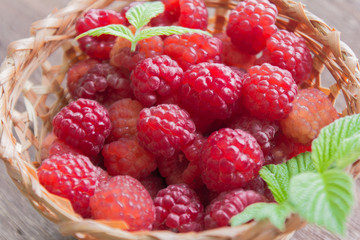 fresh ripe raspberries in a basket close-up