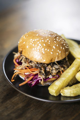 pulled pork and coleslaw salad burger sandwich with fries meal