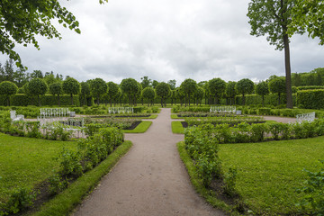 Summer Park with alleys and benches near the footpaths.
