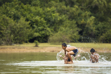 Asian boys and friends are playing water.