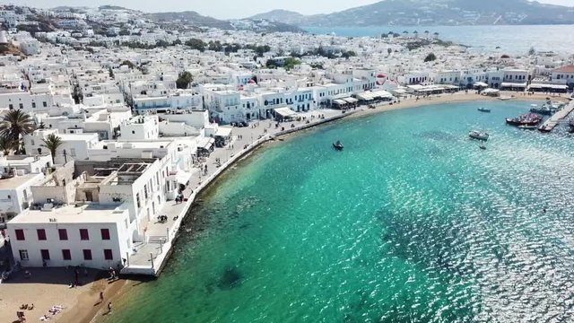 Aerial drone bird's eye view video of iconic old port in chora of Mykonos island, Cyclades, Greece