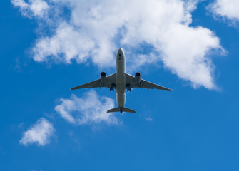 The plane flies against the sky.
