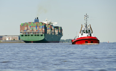 Container ship and harbour tow boat