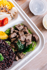 Clean food meal box: Diced grilled beef served with rice berry, broccoli, bean sprout, corn, mushroom and tomato.