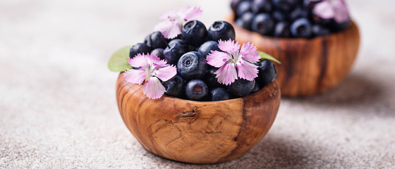 Fresh ripe blueberries in wooden bowl