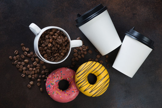 Donuts with coffee on a brown metal background, view from above, horizontal shot