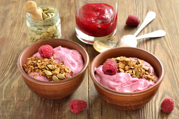 Obraz na płótnie Canvas Raspberry smoothie with granola and pumpkin seeds
