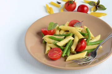 Penne pasta with green beans, cherry tomatoes and basil