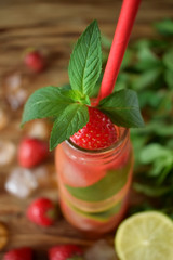 Fresh mint on top of a bottle of strawberry lemonade