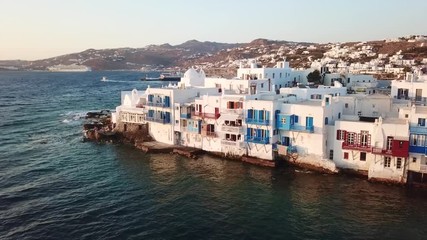 Aerial drone bird's eye view video of iconic little Venice and church of Paraportiani in chora of Mykonos island, Cyclades, Greece