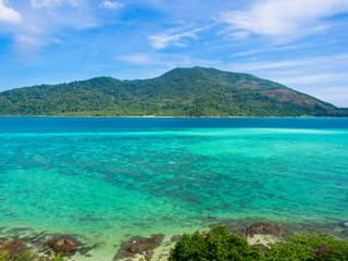 Fototapeta premium Aerial view of Koh Lipe island in Thailand,turquoise water sea,green moutain and blue sky in sunny summer day for travel destination or vacations holiday concept.