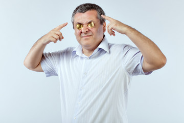 Fototapeta premium Portrait of a businessman on a white background. He squeezed his eyes bitcoins.