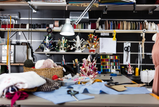 Image of workplace in sewing shop of variety clothes factory