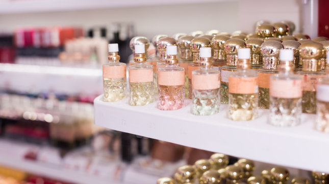 Bottles of modern perfume for sale on shelves