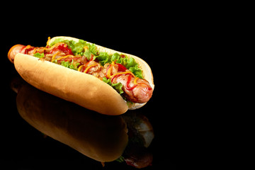 Tasty hot dog with reflection on black background