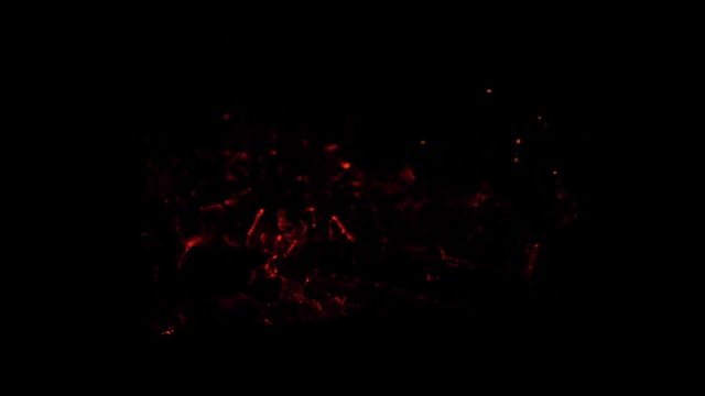 red hot coals of the fire glow at night, Slow motion.