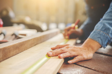 Carpenter working on woodworking machines in carpentry shop. woman works in a carpentry shop.