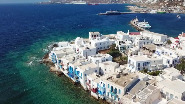 Aerial drone bird's eye view video of iconic little Venice and church of Paraportiani in chora of Mykonos island, Cyclades, Greece