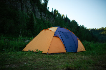 Camping in the clearing in the morning. Tents in the camping in the evening. recreation group of people