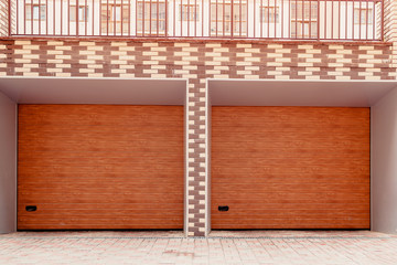 Wooden double garage door. Modern garage in new building