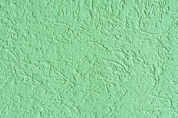texture of the surface of the wall covered with decorative plaster of the woodworm type