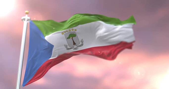 Flag of Equatorial Guinea waving at wind at sunset in slow, loop