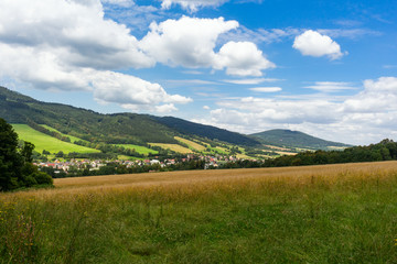 Majestic landscape of mountains and Meadow. Cycling mountain road. Misty mountain road in high mountains.. Cloudy sky with mount