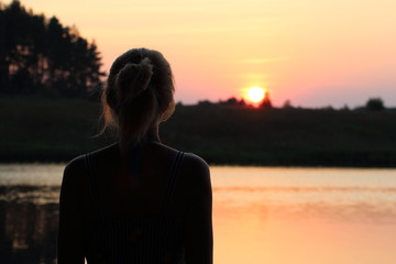 Girl looks at the sunset