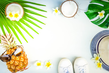 Summer flat lay frame with funny pineapple friut and tropical leaves, summer travel vacation concept, retro toned