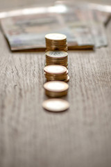 Selective focus photograph. Stack with 1 euro coins and banknotes in the background.