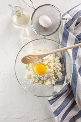 the process of making cheesecakes. Curd in a glass Cup on a white background. Flatlay. Top view. copyspace.