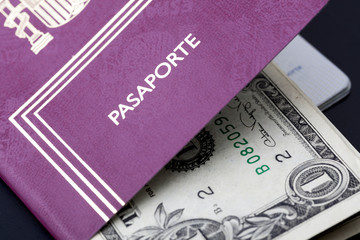 Spanish passport with money dollars