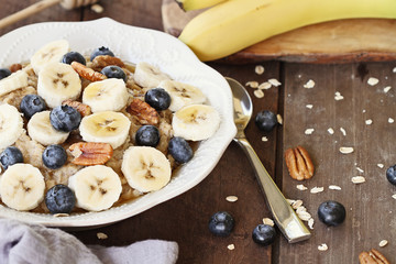 Bowl of Oatmeal Bananas, Pecans, honey and Blueberries
