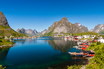 Famous village Reine with Rorbu huts in sunny weather, Lofoten islands, Norway