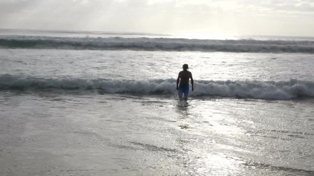 Man walking to sea in gold coast queensland australia