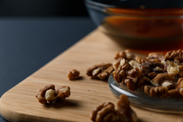 Healthy Breakfast ingredients: honey, walnuts on a dark background. Healthy diet. Close up.