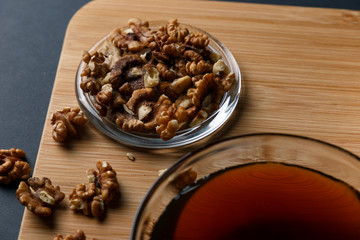 Healthy Breakfast ingredients: honey, walnuts, on a dark background. Healthy diet. Close up.