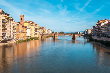 Colorful old buildings line the Arno River in Florence, Italy