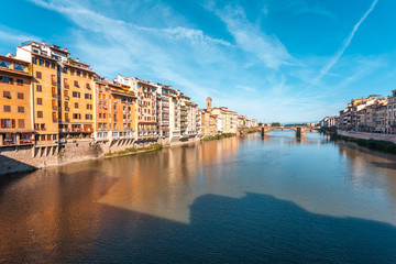 Colorful old buildings line the Arno River in Florence, Italy