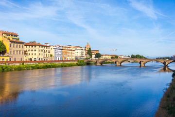 Colorful old buildings line the Arno River in Florence, Italy