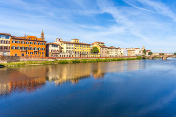 Colorful old buildings line the Arno River in Florence, Italy