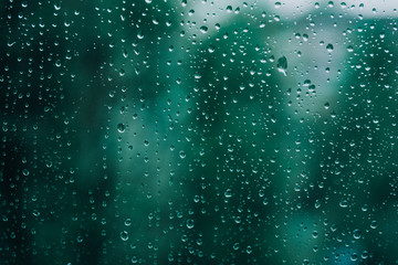 Obraz na płótnie Canvas Aquamarine freshness after the rain. The texture of the drops on the glass.