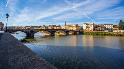 Obraz premium Colorful old buildings line the Arno River in Florence, Italy