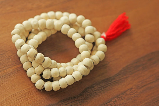 Buddhist beads. Rosary or beads from the sacred tree of Tulasi with a red tassel