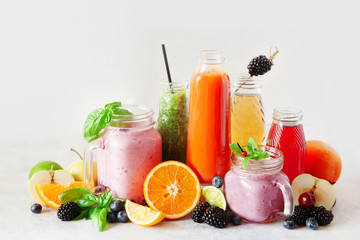 Selection of colourful smoothies and fresh juices on white background