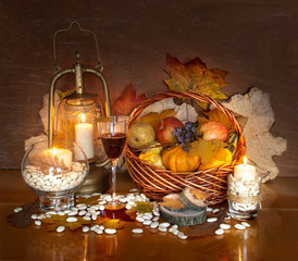 Thanksgiving Day decoration with candles, fruits, vegetables and glass of wine